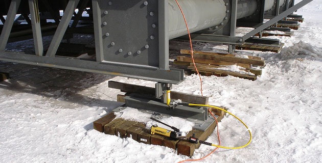 Lightweight jacking equipment for initial and periodic leveling of the Arctic Surface Foundation©.   <em>Photo courtesy of Dowland Construction Inc.</em>